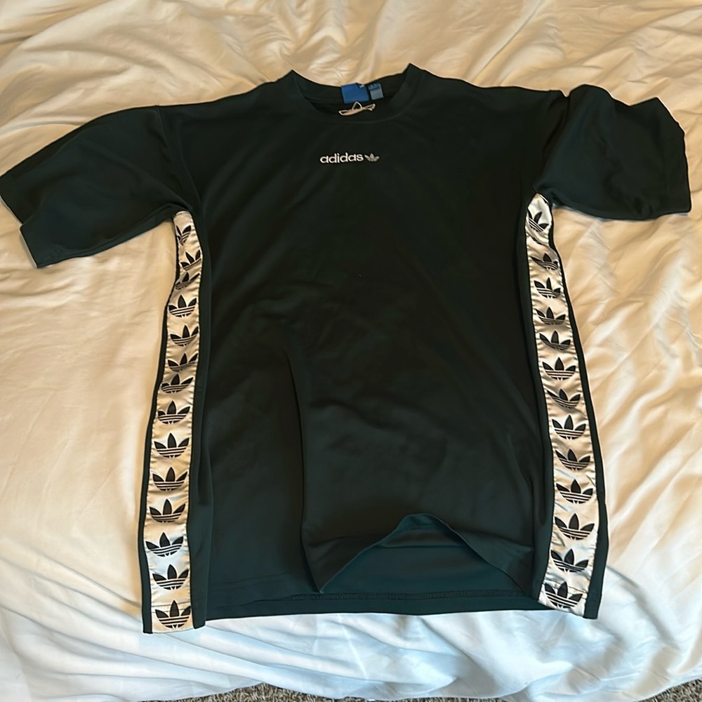 Green Adidas T shirt with white detail on sides.
